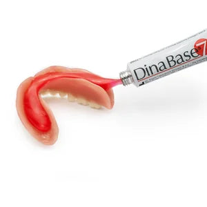 DinaBase7 adhesive gel being applied to a lower denture